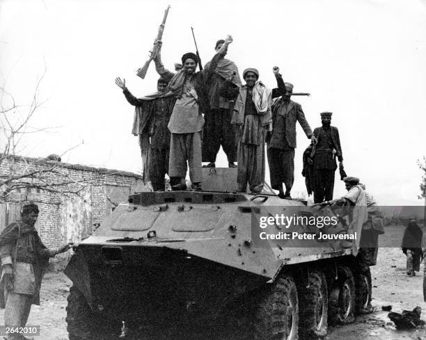 Jubilant Afghan guerrillas on a captured Russian armoured personnel carrier during the war between Afghanistan and the USSR.