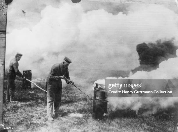 German soldiers taking advantage of a suitable wind to emit poison gas from cylinders.