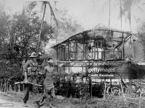 British soldier with a Japanese sniper he captured near Pegu, Burma.