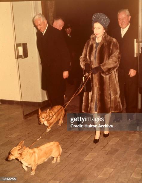 Queen Elizabeth at Liverpool Street Station with two of her pet Corgis.
