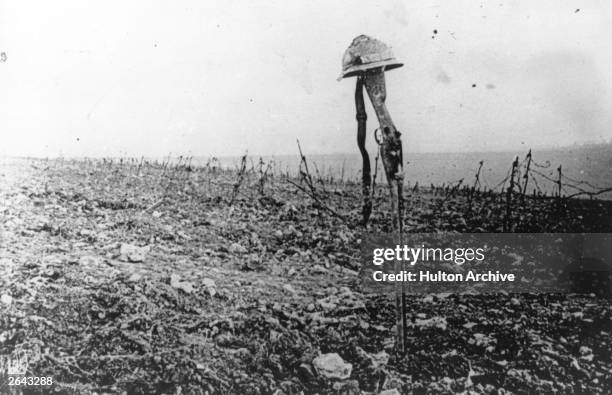 French soldier's grave, marked by his rifle and helmet, on the battlefield of Verdun.