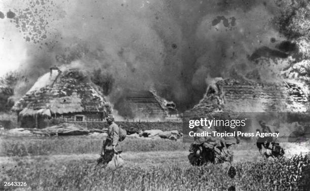 Austrian Infantry passing through a burnt-out village.