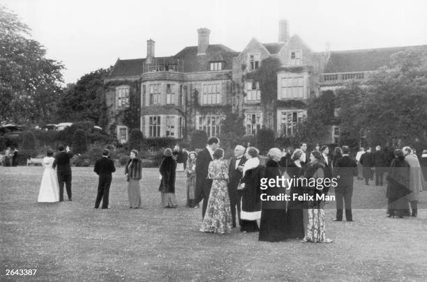 The audience enjoy an interval in the gardens of Glyndebourne Opera House, Sussex. Original Publication: Picture Post - 164 - Glyndebourne - pub. 1939