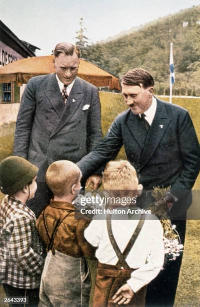 Adolf Hitler greeted by children.