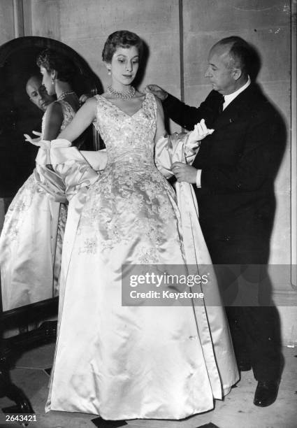 Christian Dior French couturier, born in Normandy with one of his own designs, a satin evening gown called Blenheim.