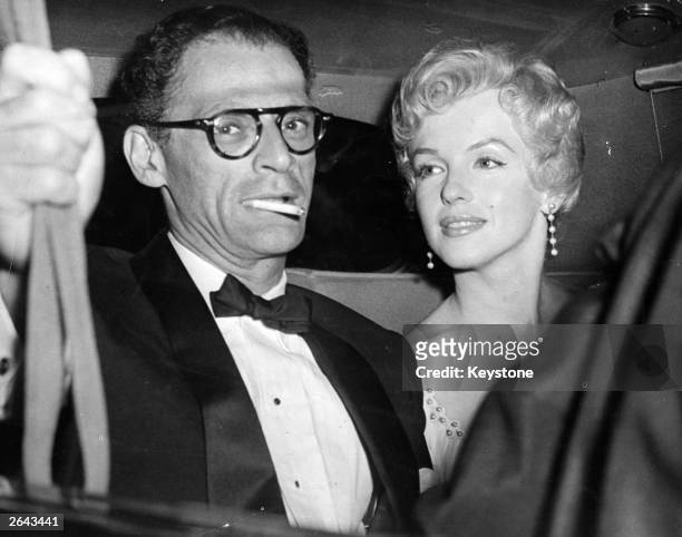 American film actress Marilyn Monroe and her husband, American playwright, Arthur Miller arrive at the Berkshire home of playwright, Terence Rattigan...