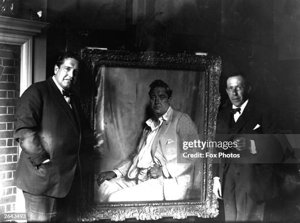 Irish-born American tenor John McCormack with his portrait, painted by Sir William Orpen.