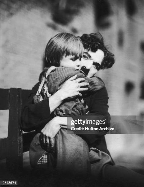 English film actor and director Charlie Chaplin , and US child actor Jackie Coogan in a scene from the film 'The Kid'.