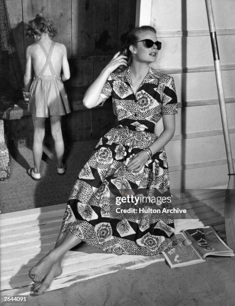 Model wearing a two-piece summer dress by Horrocks with large floral patterns. Original Publication: Housewife Magazine - pub. 1950