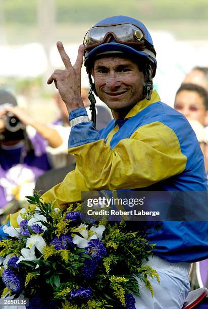 Alex Solis riding Pleasantly Perfect celebrate in the winner's circle in the $4 Million Breeders' Cup Classic, Powered by Dodge part of the 2003...