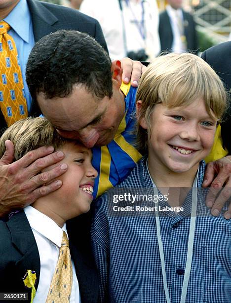 Jockey Alex Solis who rode horse, Pleasantly Perfect, embraces his sons in the winner's circle after winning the $4 Million Breeders' Cup Classic,...