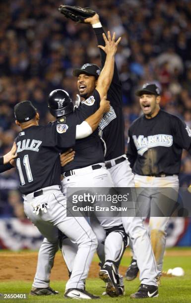 Derrek Lee , Ivan Rodriguez Alex Gonzalez and Mike Lowell of the Florida Marlins celebrate after defeating the New York Yankees 2-0 in game six of...