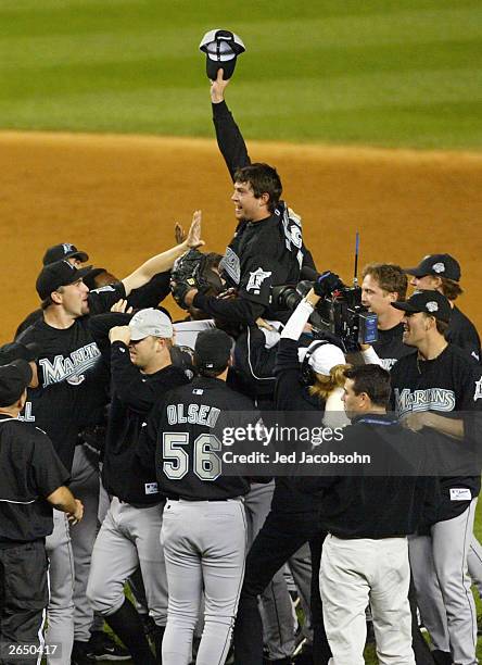 The Florida Marlins hoist up pitcher Josh Beckett the 2003 World Series MVP after defeating the New York Yankees 2-0 in game six of the Major League...