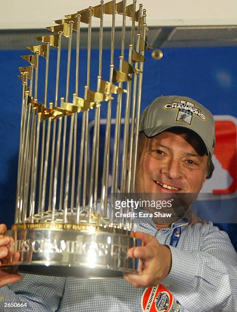 Florida Marlins team owner Jeffrey Loria celebrates with the 2003 World Series Championship trophy after defeating the New York Yankees 2-0 in game...