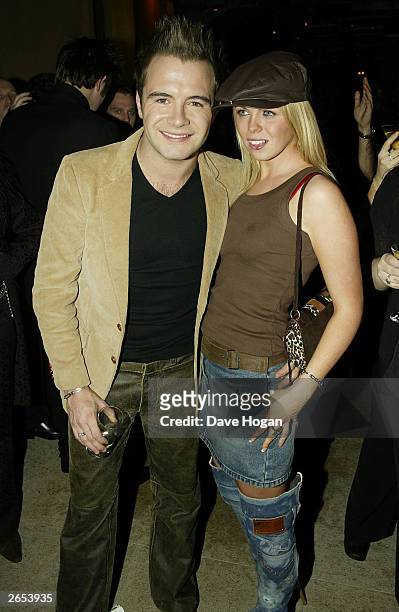 Irish pop star Shane Filan and his girlfriend attend Westlife's "Unbreakable" album launch at the Zuma Restaurant on November 11, 2002 in London.