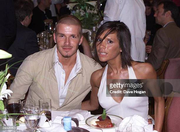 British footballer David Beckham and his wife British pop star Victoria Beckham attend the Silver Clef Awards at the Intercontinental Hotel on May...