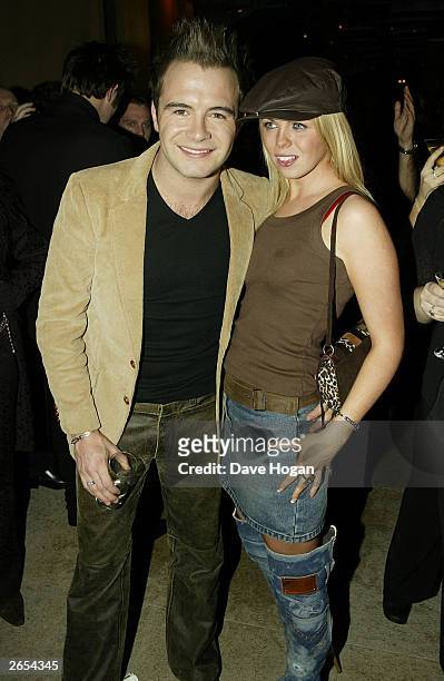 Irish pop star Shane Filan and his girlfriend attend Westlife's "Unbreakable" album launch at the Zuma Restaurant on November 11, 2002 in London.