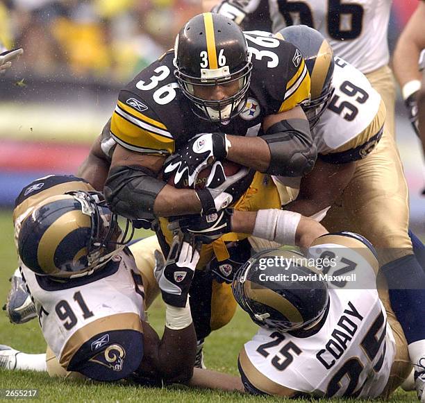 Running back Jerome Bettis of the Pittsburgh Steelers carries the ball against Leonard Little, Jamie Duncan, and Rich Coady of the St. Louis Rams on...