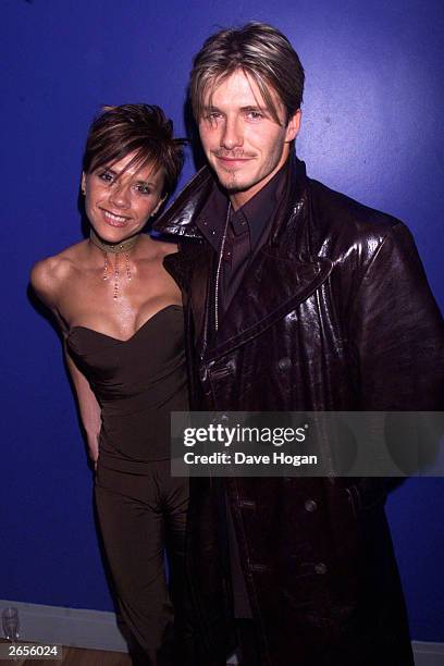 British pop star Victoria Beckham and British footballer David Beckham arrive at the charity premiere of the film "Withnail and I" at the Odeon West...