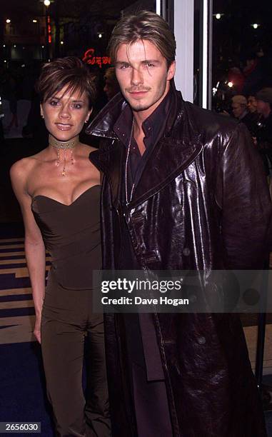 British pop star Victoria Beckham and British footballer David Beckham arrive at the charity premiere of the film "Withnail and I" at the Odeon West...