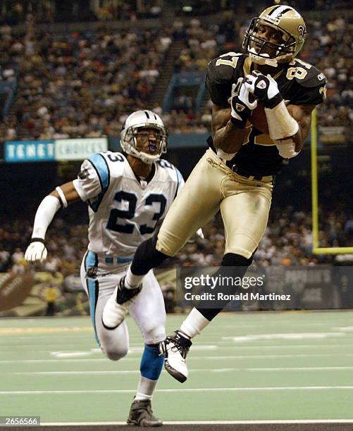 Wide receiver Joe Horn of the New Orleans Saints catches a pass for a touchdown past the defense of Reggie Howard of the Carolina Panthers October...