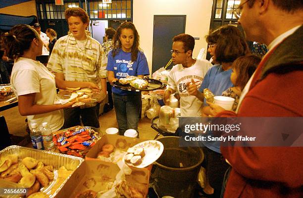 Volunteers give out food to evacuated victims at Mira Mesa High School after they were evacuated from their homes due to a huge set of wildfires...