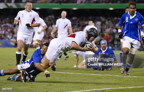 England's prop Phil Vickery dives over the line to score and seal their match against Samoa at the Telstra Dome in Melbourne 26 October 2003. England...