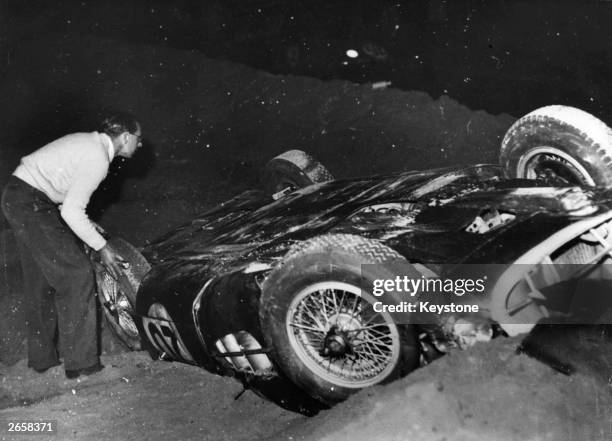 Tony Brooks' Aston Martin lying on its roof after crashing during the Le Mans 24-hour race in France.