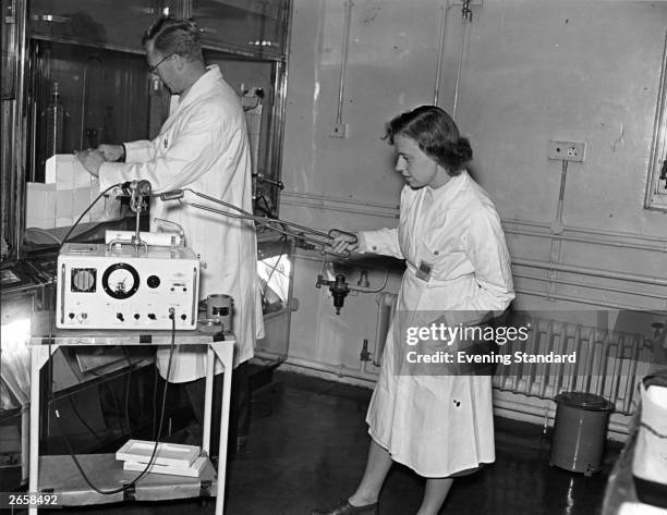 Scientific officer Rose Millett and Dr J E Johnston at work at the atomic research centre at Harwell, England.