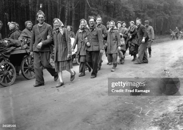 French prisoners of war, liberated women in their striped prison garb and political prisoners of all nationalities returning home on the road West of...