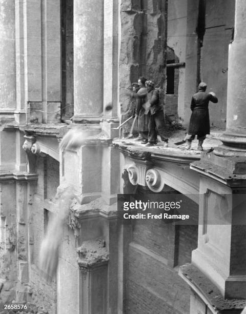 The women of Dresden clearing debris from the floor of the Zwinger art gallery, during post-war rebuilding of the bomb-damaged city.
