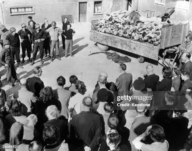 Weimar citizens, under military police escort, are forced to see for themselves the atrocities inside the concentration camp at Buchenwald.