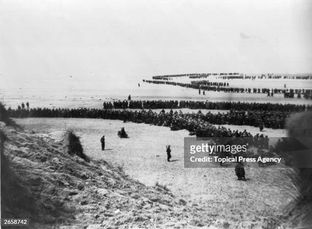 Defeated British and French troops waiting on the dunes at Dunkirk to be picked up by the Destroyers and taken back to England.