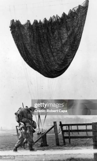 Paratrooper of the 17th US Airborne Division carries an injured fellow soldier to a first aid station near Wesel in Germany, during the Allied...