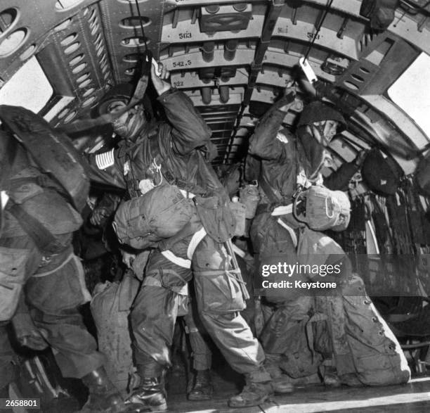 Men of the 17th US Airborne Division prepare to jump at Wesel on the Dutch border during the operation to secure the Rhine crossing. Hungarian-born...