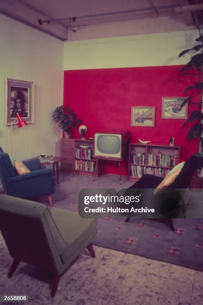 S sitting room, complete with red panelled wall and television set.