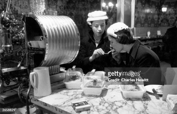 Two women having coffee at Fortnum and Mason's, an exclusive store in Piccadilly, London. Original Publication: Picture Post - 7249 - A Red Head in...