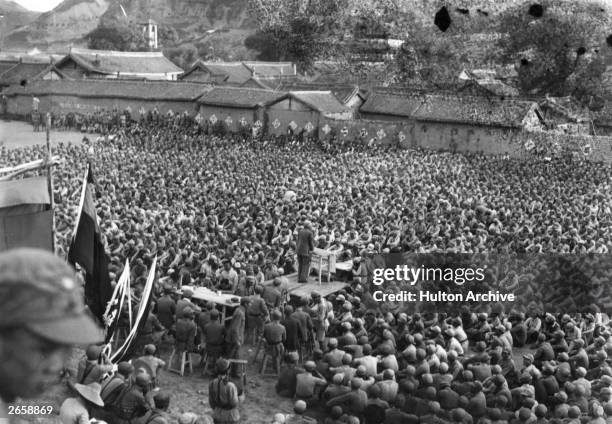 Communist cadre leader addresses a crowd of survivors of the Long March in north China.