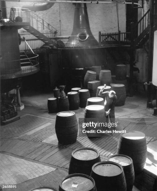 Cooper at work making barrels in Coates Gin Distillery, Plymouth. Original Publication: Picture Post - 7161 - The Best And Worst Of British Cities 4...