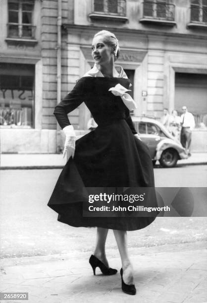 Model wearing a black and white dress with detachable scarf by Lanvin. Original Publication: Picture Post - 7264 - Fashion's New Alphabet - pub.1954