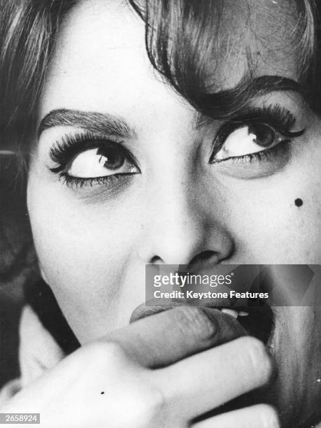 Italian film actress Sophia Loren on the phone to her mother.