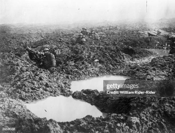 Soldiers of the 16th Canadian machine gun regiment using shell holes as makeshift defences at Passchendaele Ridge.