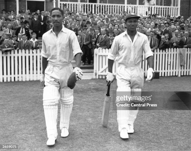 West Indies cricketers Frank Worrell , and Everton Weekes go out to resume their record-making innings against England at Trent Bridge.