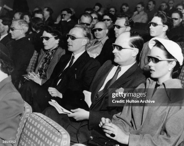 Cinema-goers wearing 3D glasses at a special Festival of Britain three dimensional film screening.