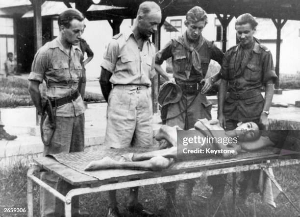 An emaciated Indonesian soldier lying in a Dutch military hospital in northern Sumatra, Indonesia, during the Indonesian war of independence. A Dutch...