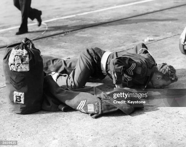 Australian army sergeant John Berry kisses the tarmac at Southampton.