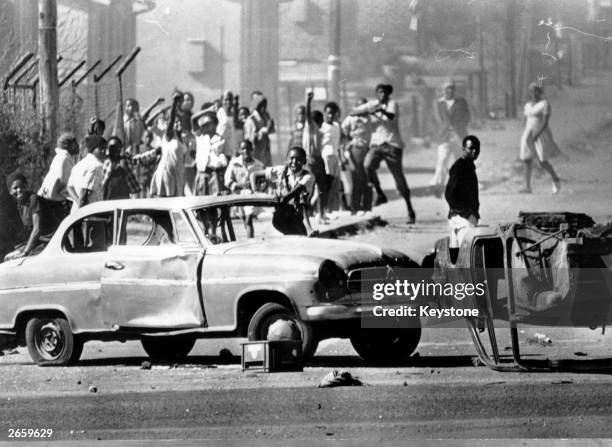 South African rioters in Soweto use cars as roadblocks during unrest stemming from protests against the use of Afrikaans in schools.