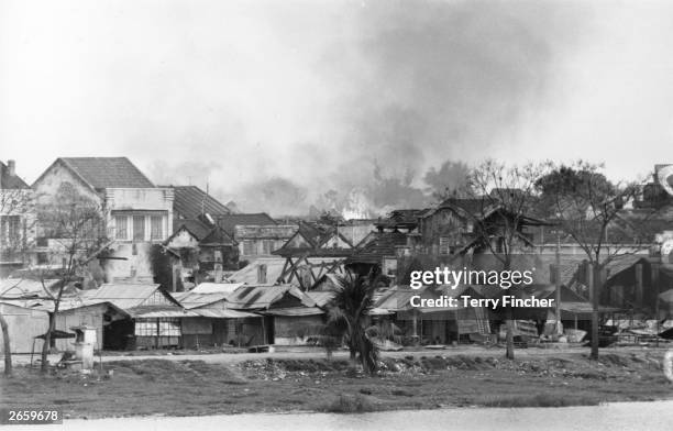 Vietnamese village burning on the banks of the Perfume River.