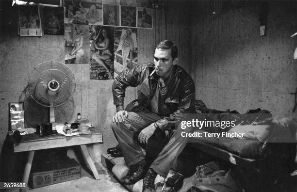 2nd Lieutenant Franc Barringer sitting on his bed in camp in Vietnam.