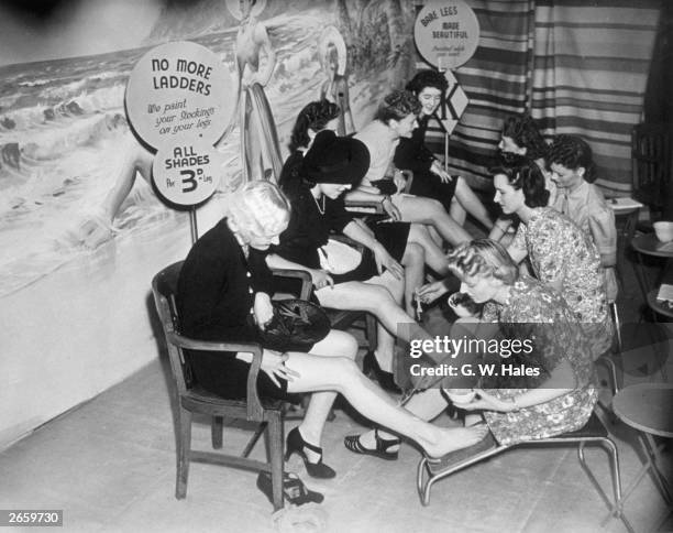 Customers have their legs painted at a store in Croydon, so they can save their coupons which would otherwise be used for stockings.
